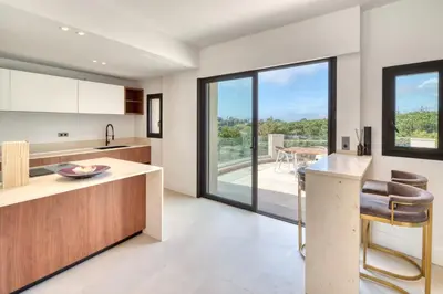 a kitchen with a counter and a table with chairs at REF 2144 - Cannes Californie- Villa for rent in Cannes