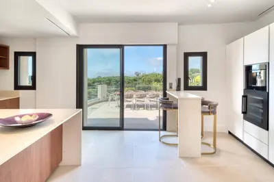 a kitchen with a view of a patio at REF 2144 - Cannes Californie- Villa for rent in Cannes