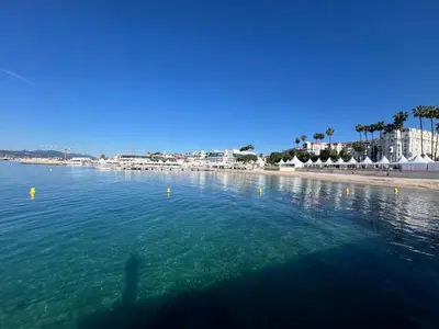 a person swimming in the water near a beach at Villa Cannes superbe vue mer in Cannes