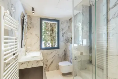 a bathroom with a toilet and a sink and a shower at Villa Cannes superbe vue mer in Cannes