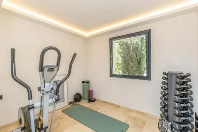 a room with a gym with a treadmill and a window at Villa Cannes superbe vue mer in Cannes