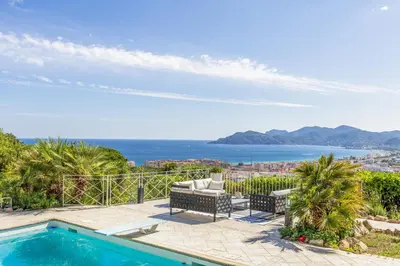 a villa with a swimming pool and a view of the ocean at Villa Cannes superbe vue mer in Cannes