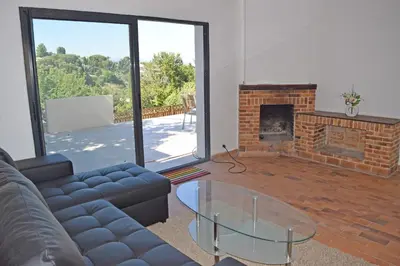 a living room with a couch and a fireplace at Villa Super Cannes avec vue mer in Vallauris
