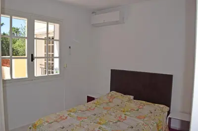 a bedroom with a bed and a window at Villa Super Cannes avec vue mer in Vallauris