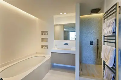 a white bathroom with a tub and a sink at REF 1238 - Cannes Croisette - Sea view apartment for rent in Cannes