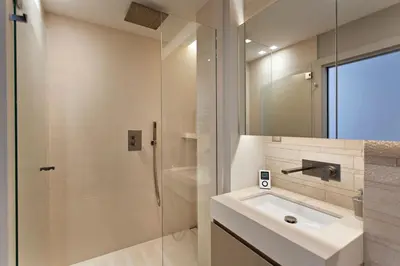 a white bathroom with a sink and a shower at REF 1238 - Cannes Croisette - Sea view apartment for rent in Cannes