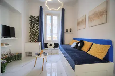 a living room with a blue couch and a tv at Agréable Studio rue ANIBES-HYPER CENTRE A0B211 in Cannes