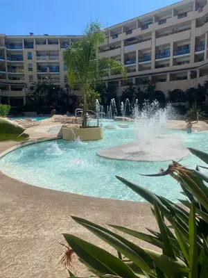 a water park in front of a large building at Apparemment proche de la mer in Cannes