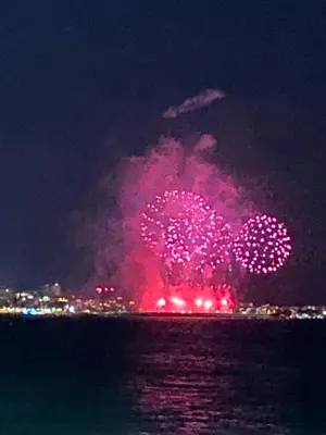 a firework display in the sky over the water at night at Apparemment proche de la mer in Cannes