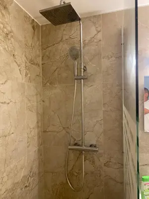 a shower with a shower head in a bathroom at Apparemment proche de la mer in Cannes