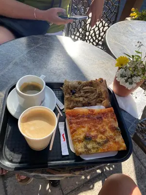 a tray of pizza and coffee on a table at Apparemment proche de la mer in Cannes
