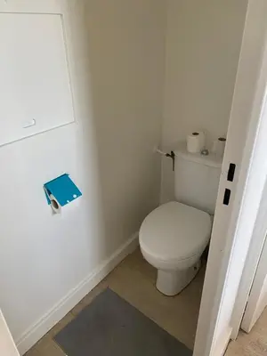 a bathroom with a toilet and a book on the door at Apparemment proche de la mer in Cannes