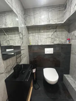 a bathroom with a white toilet and a black sink at La pause cannoise RDC in Cannes