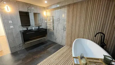 a bathroom with a bath tub and a sink at La pause cannoise RDC in Cannes