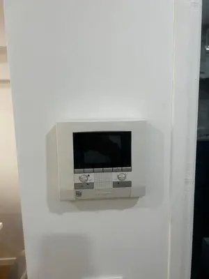 a tv on a wall in a white wall at La pause cannoise RDC in Cannes