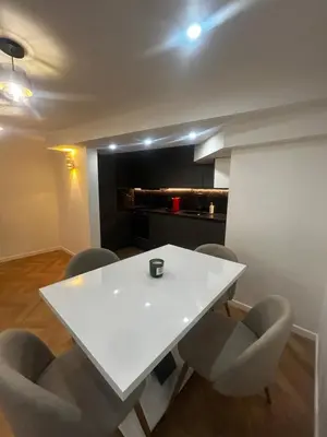 a white table and chairs in a room at La pause cannoise RDC in Cannes