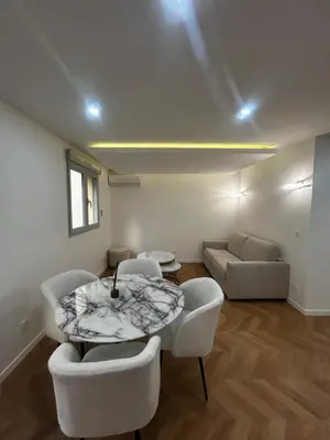 a living room with a table and chairs and a couch at Escapade Cannoise in Cannes