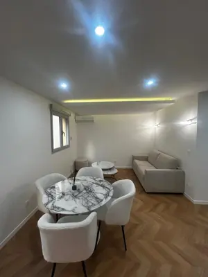 a living room with a table and chairs and a couch at Escapade Cannoise in Cannes