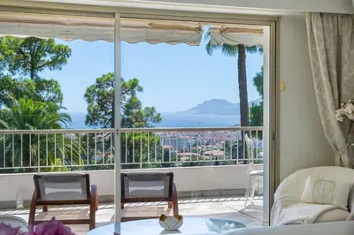 a living room with a large window with a view at Spacious 1-Br with Sea View Residence with Pool Cannes in Cannes