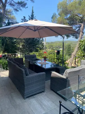 a patio with a table and an umbrella at Cocon in Le Cannet