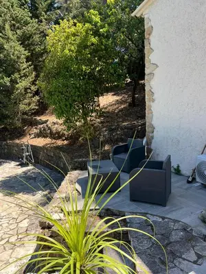 a patio with couches and plants next to a building at Cocon in Le Cannet