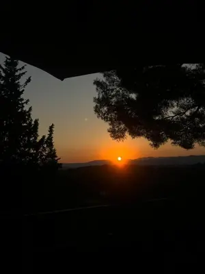 a sunset with the sun setting in the distance at Cocon in Le Cannet