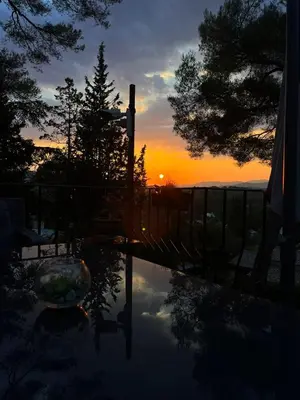 a sunset with a reflection in a pool of water at Cocon in Le Cannet