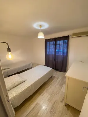 a bedroom with two beds and a window at Cocon in Le Cannet