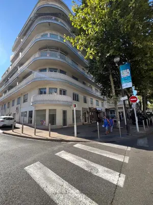 a large white building on the corner of a street at Family Flat Cannes Centre in Cannes