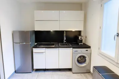 a kitchen with a sink and a washing machine at Family Flat Cannes Centre in Cannes
