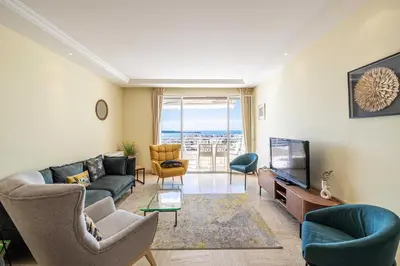 a living room with a couch and a tv at Flat -2BDR-4P - SEA VIEW in Cannes