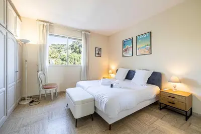 a bedroom with a large white bed and a window at Flat -2BDR-4P - SEA VIEW in Cannes