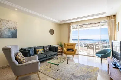 a living room with a couch and a table at Flat -2BDR-4P - SEA VIEW in Cannes