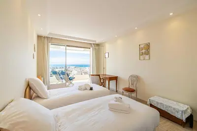 a hotel room with two beds and a window at Flat -2BDR-4P - SEA VIEW in Cannes