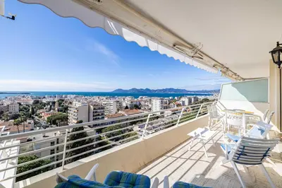 a balcony with chairs and a view of the city at Flat -2BDR-4P - SEA VIEW in Cannes