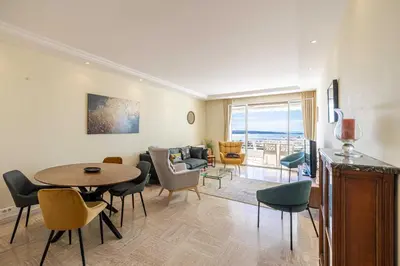 a living room with a table and chairs at Flat -2BDR-4P - SEA VIEW in Cannes
