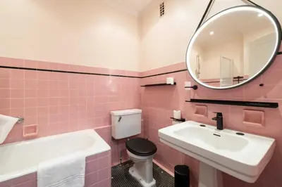 a pink bathroom with a sink and a mirror at Flat -2BDR-4P - SEA VIEW in Cannes