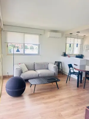 a living room with a couch and a table at Cannes Croix des Gardes in Cannes