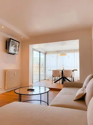 a living room with a couch and a table at Le Noé By ApiRent #Climatisation #Wifi #Balcon in Cannes