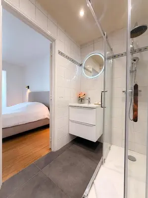 a bathroom with a shower and a sink and a bed at Le Noé By ApiRent #Climatisation #Wifi #Balcon in Cannes
