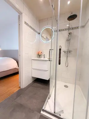 a shower with a glass door in a bathroom at Le Noé By ApiRent #Climatisation #Wifi #Balcon in Cannes