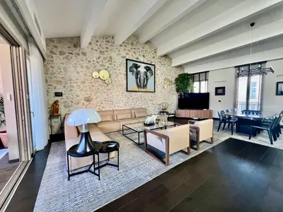 a living room with a couch and a table at Cannes hyper centre appartement luxe 5 étoiles terrasse in Cannes