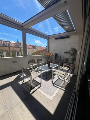 a patio with a table and chairs on a balcony at Cannes hyper centre appartement luxe 5 étoiles terrasse in Cannes