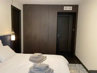 three towels are stacked on a bed in a room at Cannes hyper centre appartement luxe 5 étoiles terrasse in Cannes