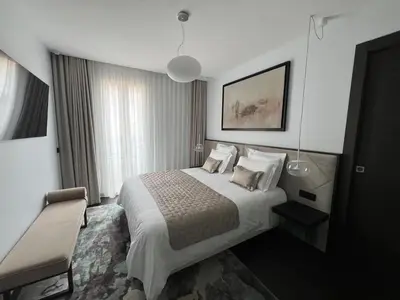 a hotel room with a bed and a chair at Cannes hyper centre appartement luxe 5 étoiles terrasse in Cannes