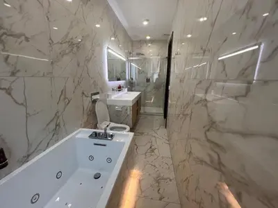 a bathroom with a white tub and a sink at Cannes hyper centre appartement luxe 5 étoiles terrasse in Cannes