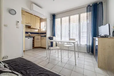 a small kitchen with a table in a room at LE BRISTOL avec balcon au calme en centre-ville in Cannes