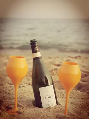 a bottle of wine in the sand on the beach at Villa de la Roche - Spacieux appartement bourgeois in Cannes