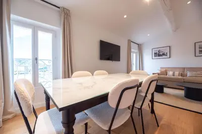 a dining room with a table and chairs at Seaview with Terrace in Cannes in Cannes