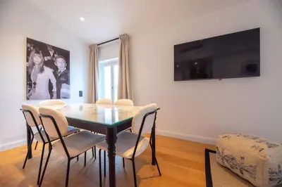 a dining room with a glass table and chairs at Seaview with Terrace in Cannes in Cannes